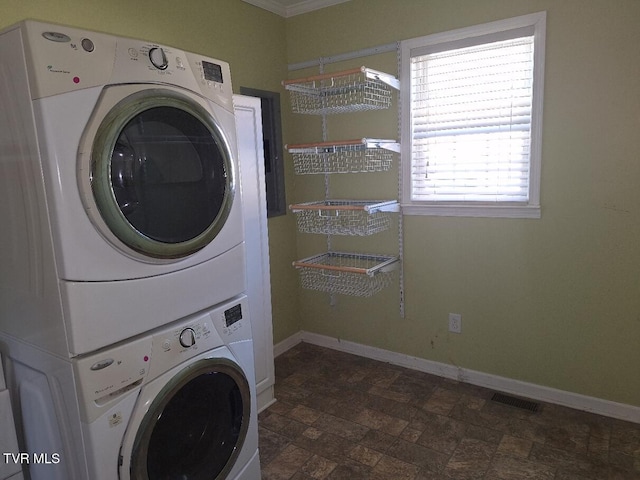 laundry room with stacked washer and dryer