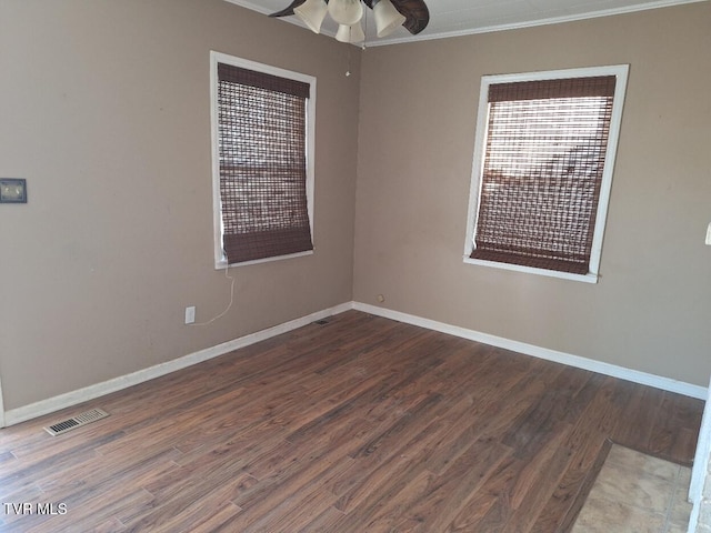 unfurnished room featuring ceiling fan, wood-type flooring, and crown molding