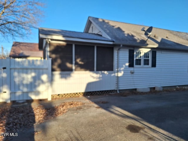 view of property exterior featuring a sunroom