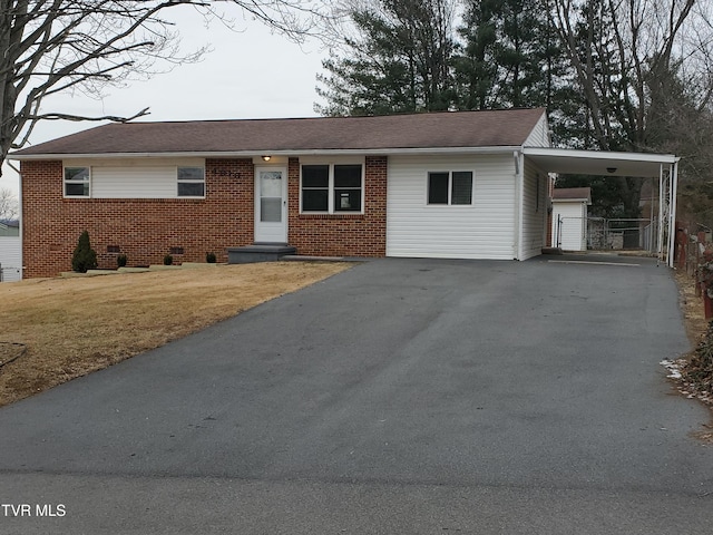 ranch-style house with a front lawn and a carport