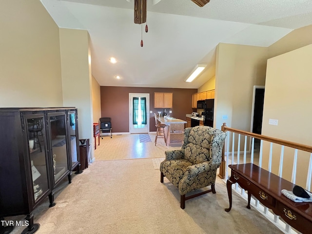 sitting room featuring vaulted ceiling and light carpet