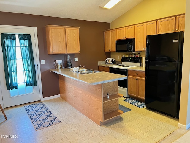 kitchen with sink, black appliances, kitchen peninsula, and lofted ceiling