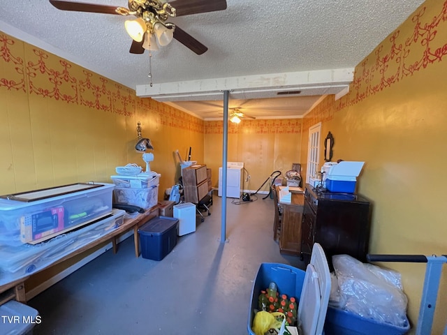 basement with ceiling fan, a textured ceiling, and washer and dryer