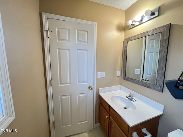 bathroom with a textured ceiling and vanity