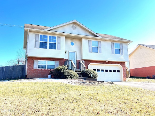 bi-level home with a garage and a front lawn