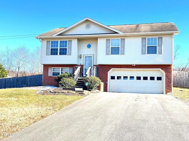 bi-level home with a front yard and a garage