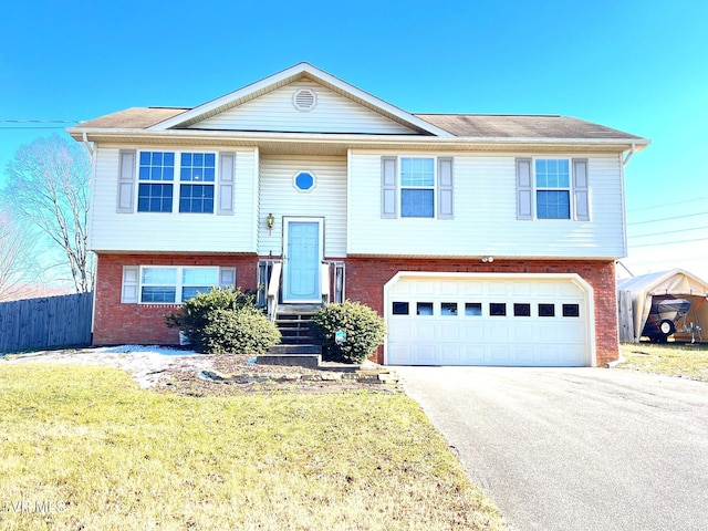 bi-level home with a front yard and a garage