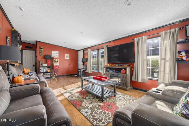 living room featuring a textured ceiling and light wood-type flooring