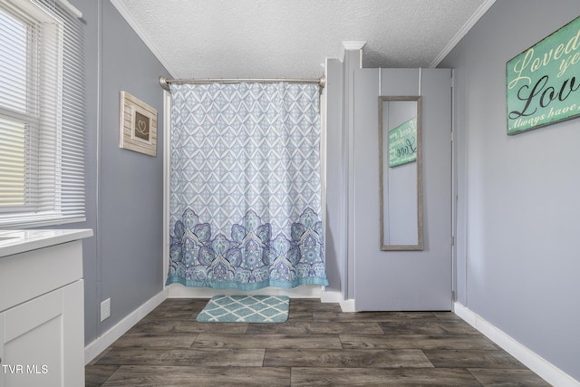 bathroom featuring crown molding, hardwood / wood-style floors, vanity, a wealth of natural light, and a textured ceiling