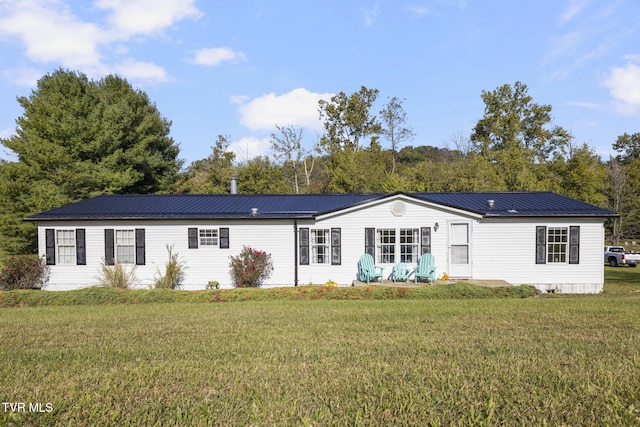 rear view of house with a yard