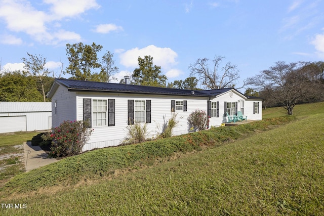 view of front of property with a garage and a front lawn