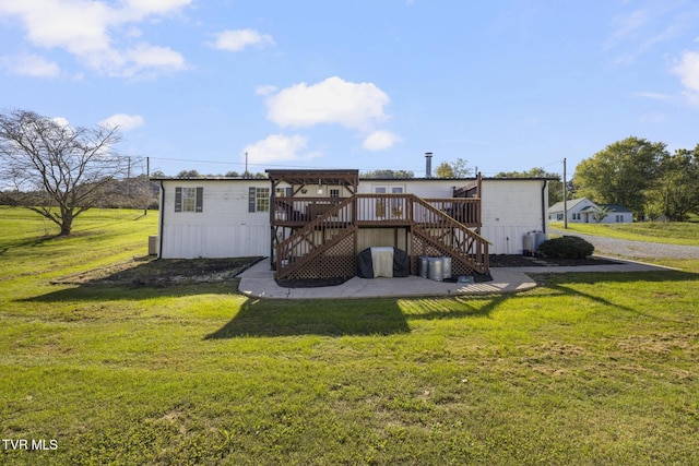 rear view of house with a deck and a lawn