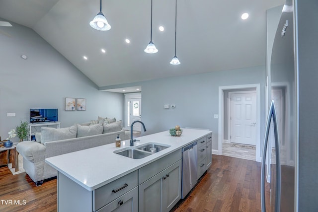 kitchen with pendant lighting, sink, a center island with sink, lofted ceiling, and stainless steel appliances