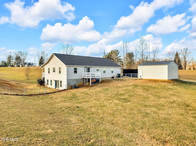 back of property featuring central AC, a yard, and a storage unit