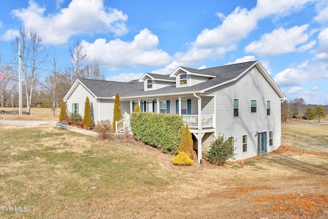 cape cod home with a porch and a front lawn