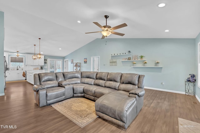 living room featuring sink, dark wood-type flooring, ceiling fan, and vaulted ceiling