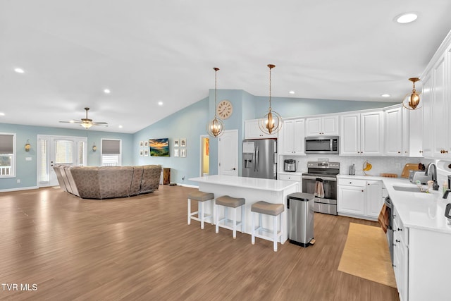 kitchen featuring appliances with stainless steel finishes, sink, and white cabinets