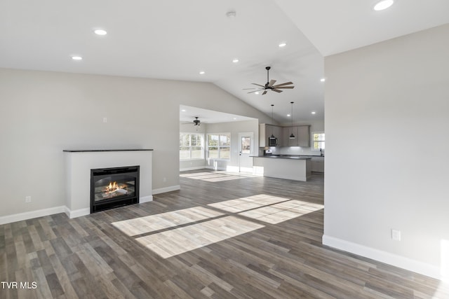 unfurnished living room with lofted ceiling and dark hardwood / wood-style flooring