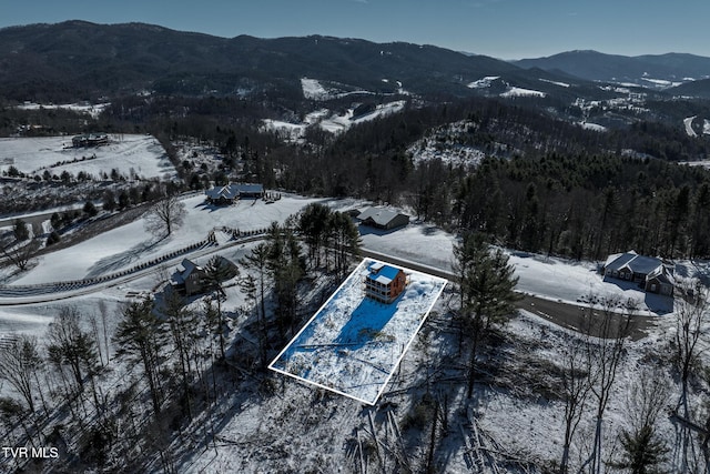 snowy aerial view with a mountain view