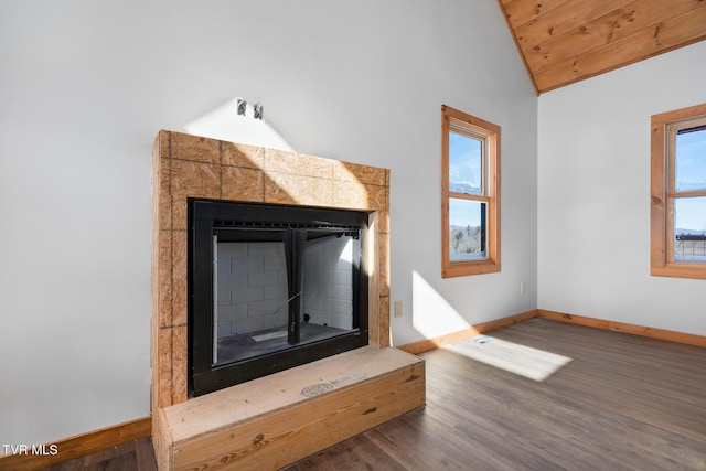 details with wood-type flooring and a tiled fireplace