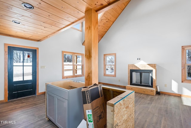 interior space featuring a tiled fireplace, hardwood / wood-style flooring, a wealth of natural light, and wooden ceiling