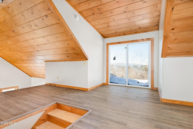 additional living space with hardwood / wood-style flooring, vaulted ceiling, and wooden ceiling