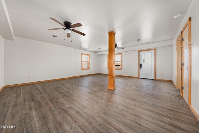 unfurnished living room with dark wood-type flooring and ceiling fan