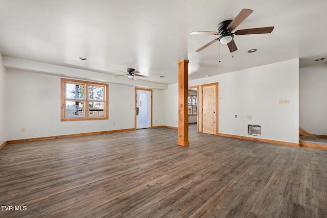 unfurnished living room with heating unit, dark hardwood / wood-style floors, and ceiling fan