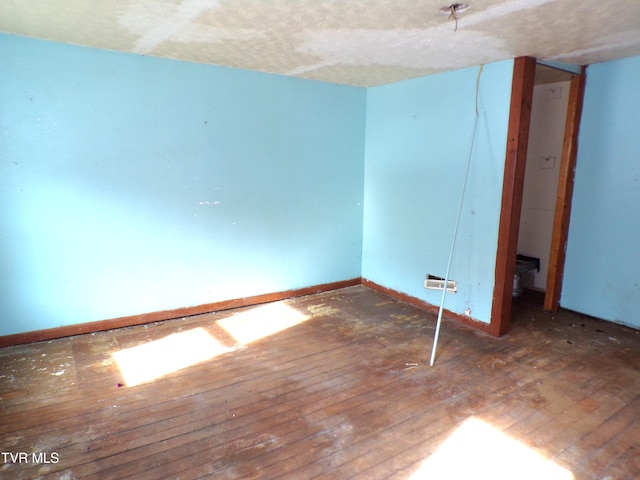 spare room featuring hardwood / wood-style floors