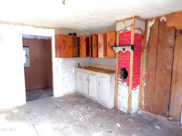 kitchen with electric panel and a textured ceiling