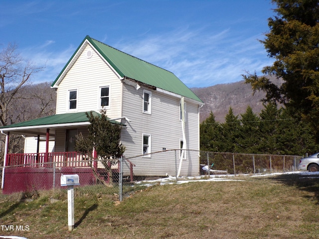 view of property exterior with a yard and covered porch