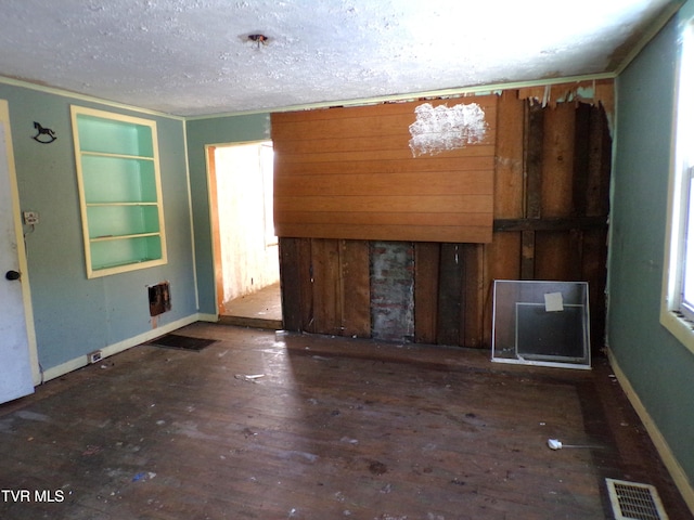 unfurnished room with dark hardwood / wood-style floors and a textured ceiling