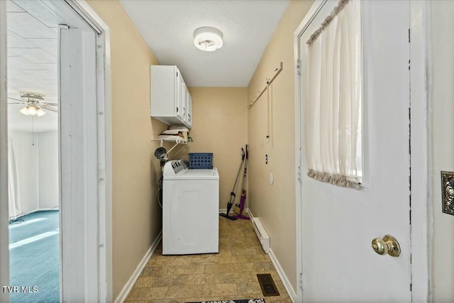 washroom with cabinets, washer and dryer, and a baseboard heating unit