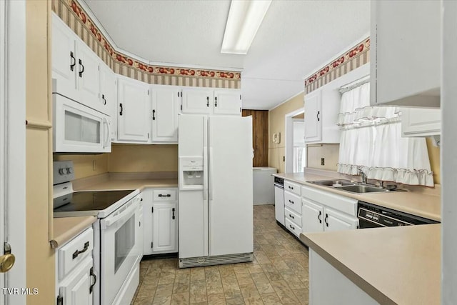 kitchen featuring white cabinetry, white appliances, and sink