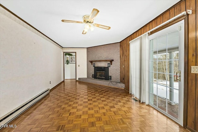 unfurnished living room with baseboard heating, parquet flooring, wooden walls, and ceiling fan