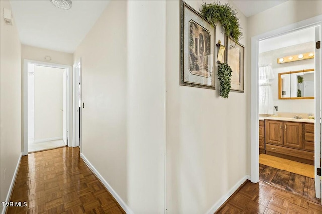 corridor featuring dark parquet flooring