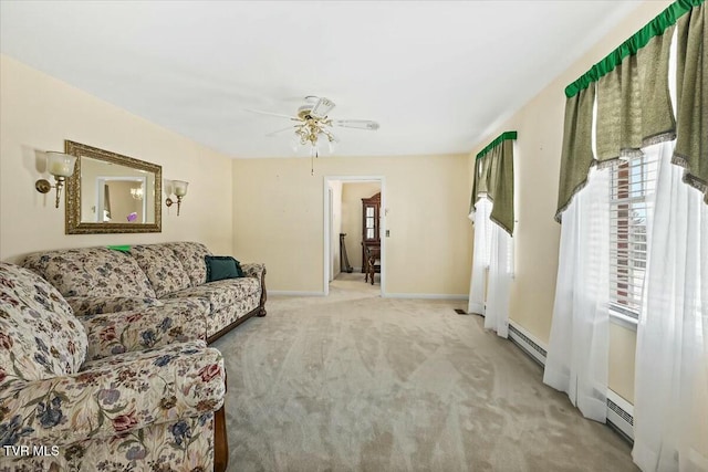 carpeted living room featuring ceiling fan and a baseboard radiator