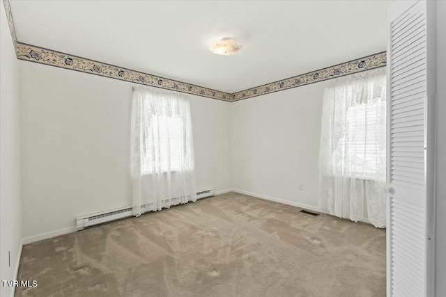 carpeted spare room with baseboard heating