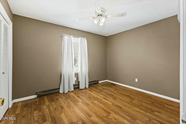 spare room featuring hardwood / wood-style floors and ceiling fan