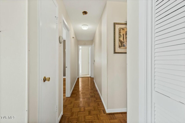 hallway featuring dark parquet flooring