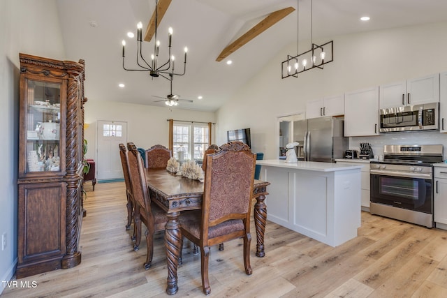 dining area with light hardwood / wood-style floors, ceiling fan with notable chandelier, beam ceiling, and high vaulted ceiling