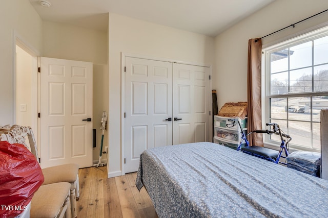 bedroom with a closet and light wood-type flooring