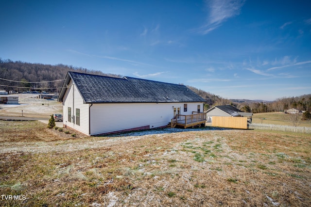 back of property featuring a wooden deck