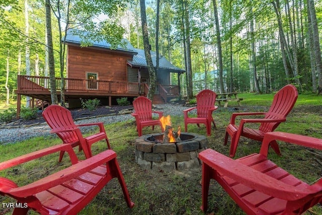 view of yard featuring a fire pit and a deck