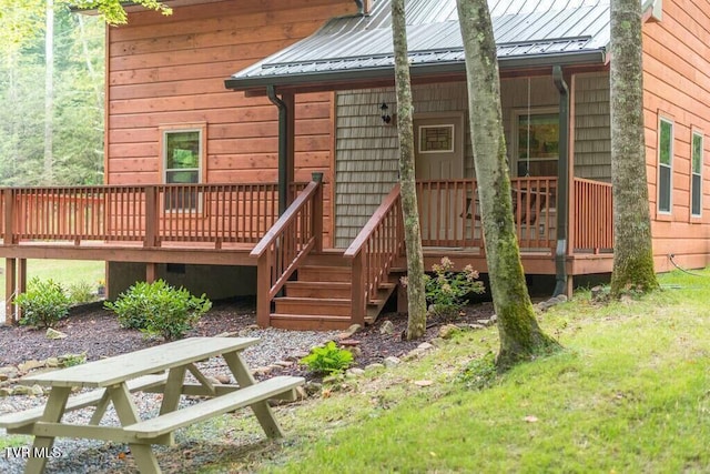 view of exterior entry featuring a deck