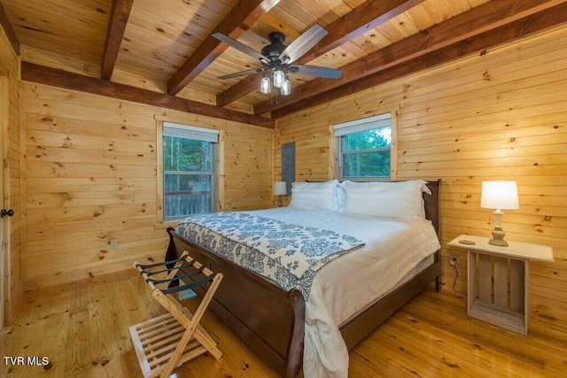 bedroom with wooden ceiling, light hardwood / wood-style floors, and wood walls