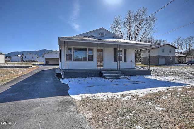 view of front of property with covered porch and a garage