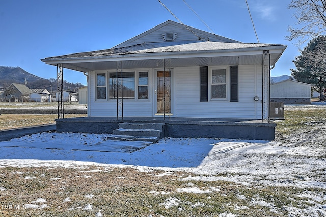 view of front of property with a porch and cooling unit