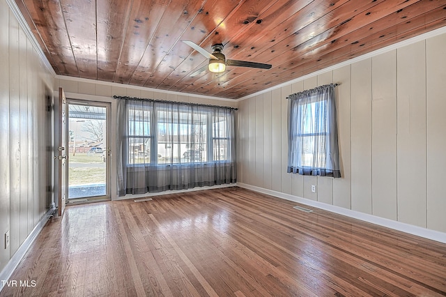 unfurnished room with wood ceiling, hardwood / wood-style flooring, a healthy amount of sunlight, and ceiling fan