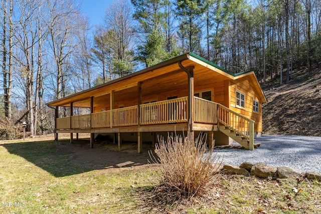 exterior space featuring stairs and a front lawn